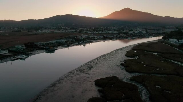 Aerial: Houses on the Corte Madera Creek at sunset. In the background is Mt Tam. Larkspur, Marin, USA