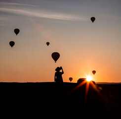 silhouette of a woman with balloons