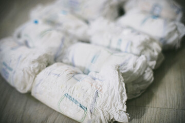 bunch of diapers. Contaminated with excrement and rolled used diapers. Recycling disposable mediums...