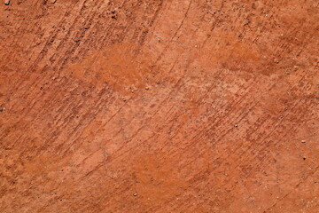 Abstract natural background from texture of orange red terracota clay soil. Rustic abstract background. Earthy colours. Concept of background, abstract, texture, natural tones, Africa.