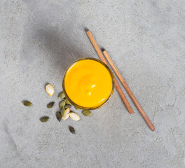 Fototapeta na wymiar Pumpkin drink, smoothie in glass with bamboo straws on a light gray background top view