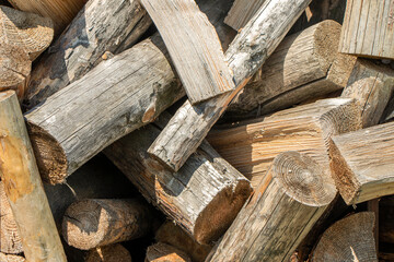 Firewood texture logs rural scene brown background. Pile of wood logs ready for winter. A pile of chopped firewood ready for stacking. High quality photo
