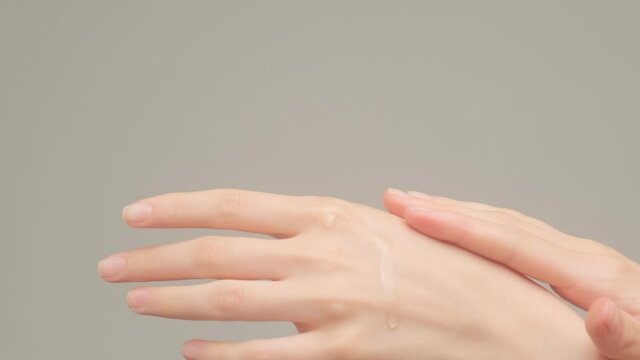 Women's hands apply a cream to moisturize the skin. Beautiful delicate skin. Hand and body care