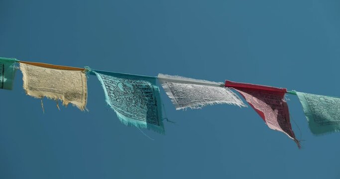 Tibetan prayer flags - colorful rectangular cloth, often found strung along trails and peaks high in Himalayas. Cinema 4K 60fps video