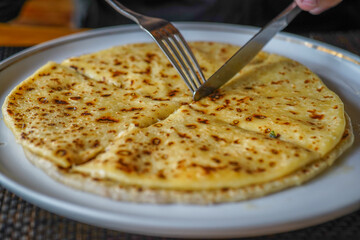 Eating Khychin Flat Bread. Traditional Caucasian Dish