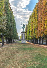 Statue dans une all&eacute;e de Paris avec le feuillage des arbres aux couleurs de l'automne