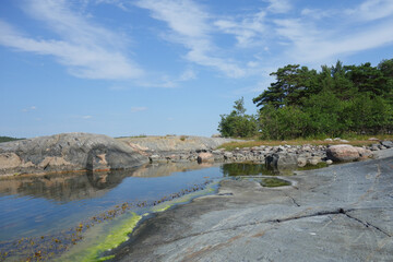 Fototapeta na wymiar Rocky island in the archipelago of Finland by the Baltic Sea in summer