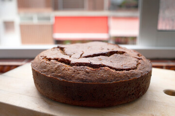 Homemade banana bread on wooden background. Home made bakery. Banana cake. Round, side view