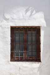 Ancient window on a white wall