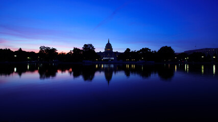 Naklejka premium The United States Capitol Reflecting Pool at Blue Hour Sunrise in the Covid 19 Pandemic Wide Shot