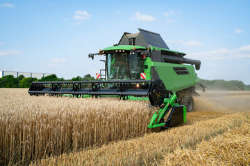 Getreideernte - Moderner Mähdrescher bei trockenem Erntewetter auf dem Feld im Einsatz.
