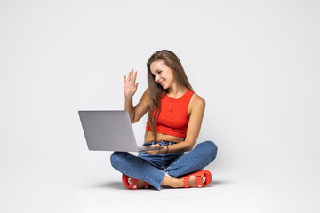 Beauty woman student sitting on floor with white wall background and video call on laptop computer