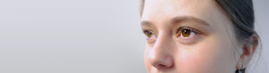 close up part of the woman's face, girl 20-29 years old, human eye looking to the side, the concept...