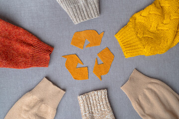 Clothing recycling. Used clothes. Ecological and sustainable fashion. sleeves of autumn woolen...