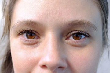 close up part of the woman's face, girl 20-29 years old, human eye looking at the camera, the...