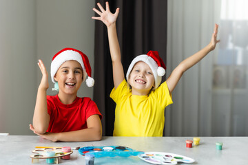 Two little sisters having fun while making christmas Nativity crafts with at home