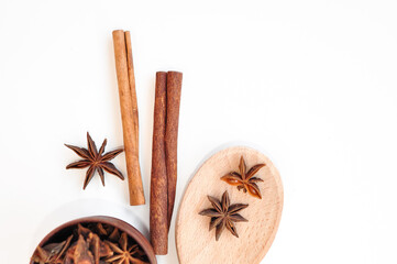 Aromatic anise stars and cinnamon on white background 