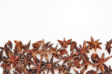 Aromatic anise stars and cinnamon on white background 