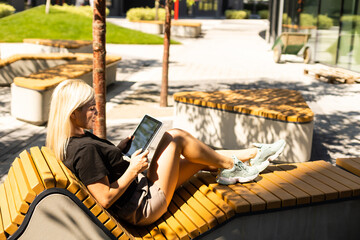 Obraz na płótnie Canvas Woman using digital tablet PC in the park.