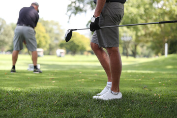 golfers hit their drives during a tournament