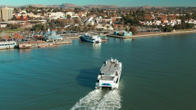 Aerial: Ferry on the Napa River and the city Of Vallejo. California, USA