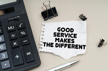 On the table is a calculator, a pen and paper with the inscription - Good Service Makes the...