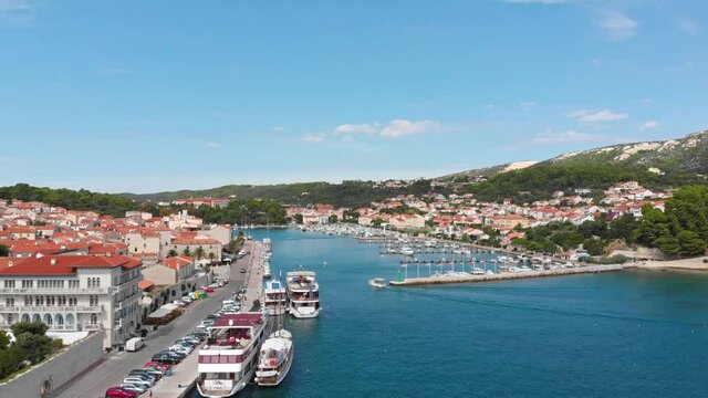 drone footage of Rab city harbour in Croatia. Summer holiday vibes. Rab Island and blue sea during sunny day.
