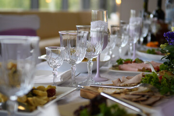 A table with food dishes in the restaurant. Festive food in the reception room.