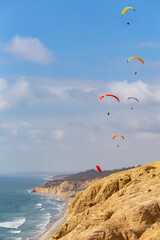 Five Paragliders Over Cliffs