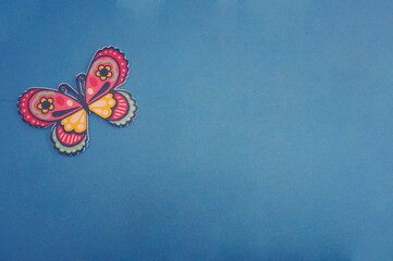 Colored Butterfly Cutout on Royal Blue Background