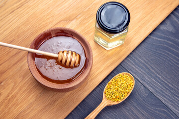 Fresh flower honey of different varieties, pollen with spoons on a wooden background. Organic Vitamin Health Food