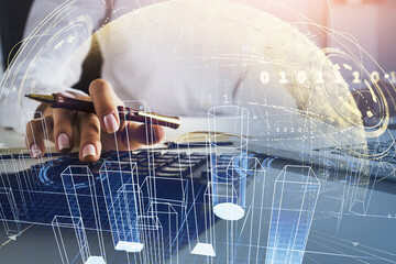 Businesswoman wearing shirt is counting on calculator and taking notes