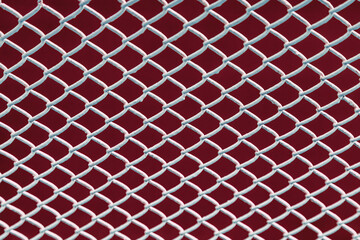 Fototapeta premium Close-up view of the surface of a white iron mesh fence