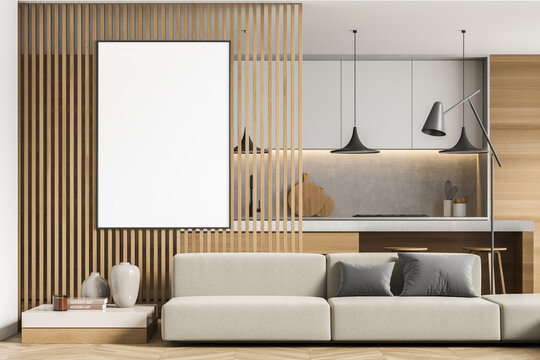 Empty canvas on wood panel partition with beige sofa and kitchen