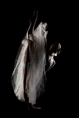 ballerina with a white dress and black top posing on black background © Nikola Spasenoski