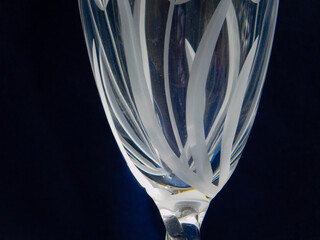 Close up of etched wine glass against dark background.  - Powered by Adobe