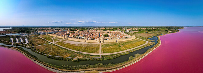 The aerial view of Aigues-Mortes, a medieval city surronded by walls in the Occitanie region of southern France - obrazy, fototapety, plakaty