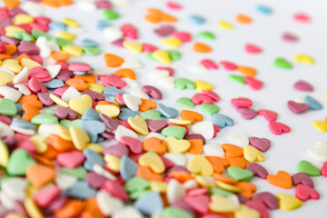 A contrasting spread of vivid heart candies against a crisp white surface, offering a blend of focus and blur, ideal for design backdrops.