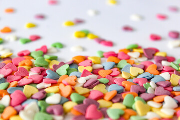 Delightful spread of heart-shaped candies over a clean white surface, capturing the essence of love and celebration.