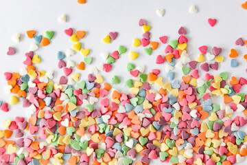 Dynamic splash of multicolored heart candies creating an energetic visual, perfect for themes of affection and joy.