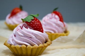 Delectable mini dessert tarts showcasing creamy swirls and a juicy strawberry, perfect for sweet indulgence moments.