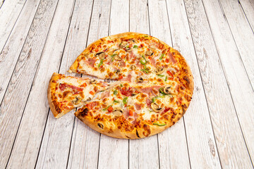 Pizza with mushrooms, green and red peppers, ham, white onion and well-toasted mozzarella cheese