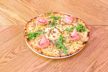 Gourmet Italian pizza with mozzarella cheese, thistle mushrooms, mortadella mortadella slices,...