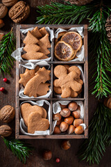 Tasty Christmas gingerbread cookies decorated with nuts and spruce
