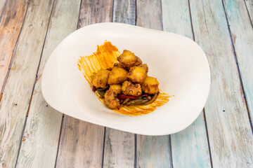 Tacos of octopus cooked and then fried in tempura on strips of red and green peppers with fried onion