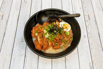 Chicken stew ramen battered with miso, noodles, chives, nori seaweed and boiled egg
