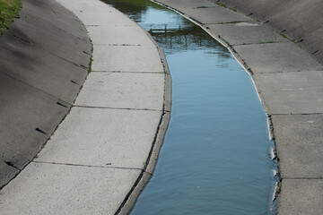 man-made concrete channel of an urban creek