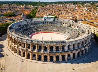 Fotobehang Oud gebouw The aerial view of Arena of Nîmes, an old Roman city in the Occitanie region of southern France
