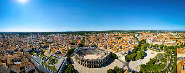 The aerial view of Arena of Nîmes, an old Roman city in the Occitanie region of southern France