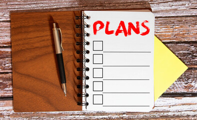 Notebook with an action plan and sticker today on wooden desk with cup of coffee and muffin